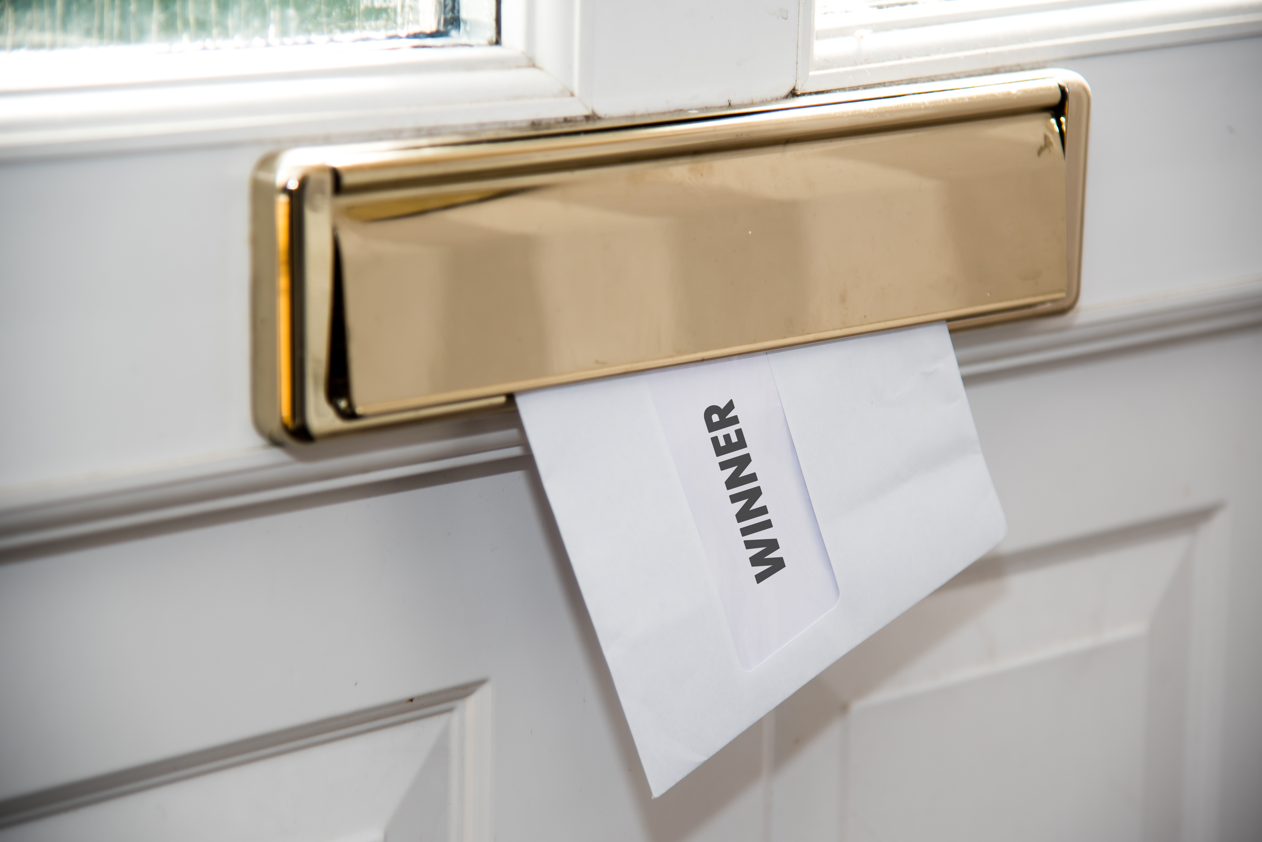Winner letter being posted through letterbox