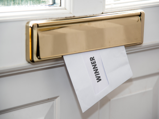 Winner letter being posted through letterbox