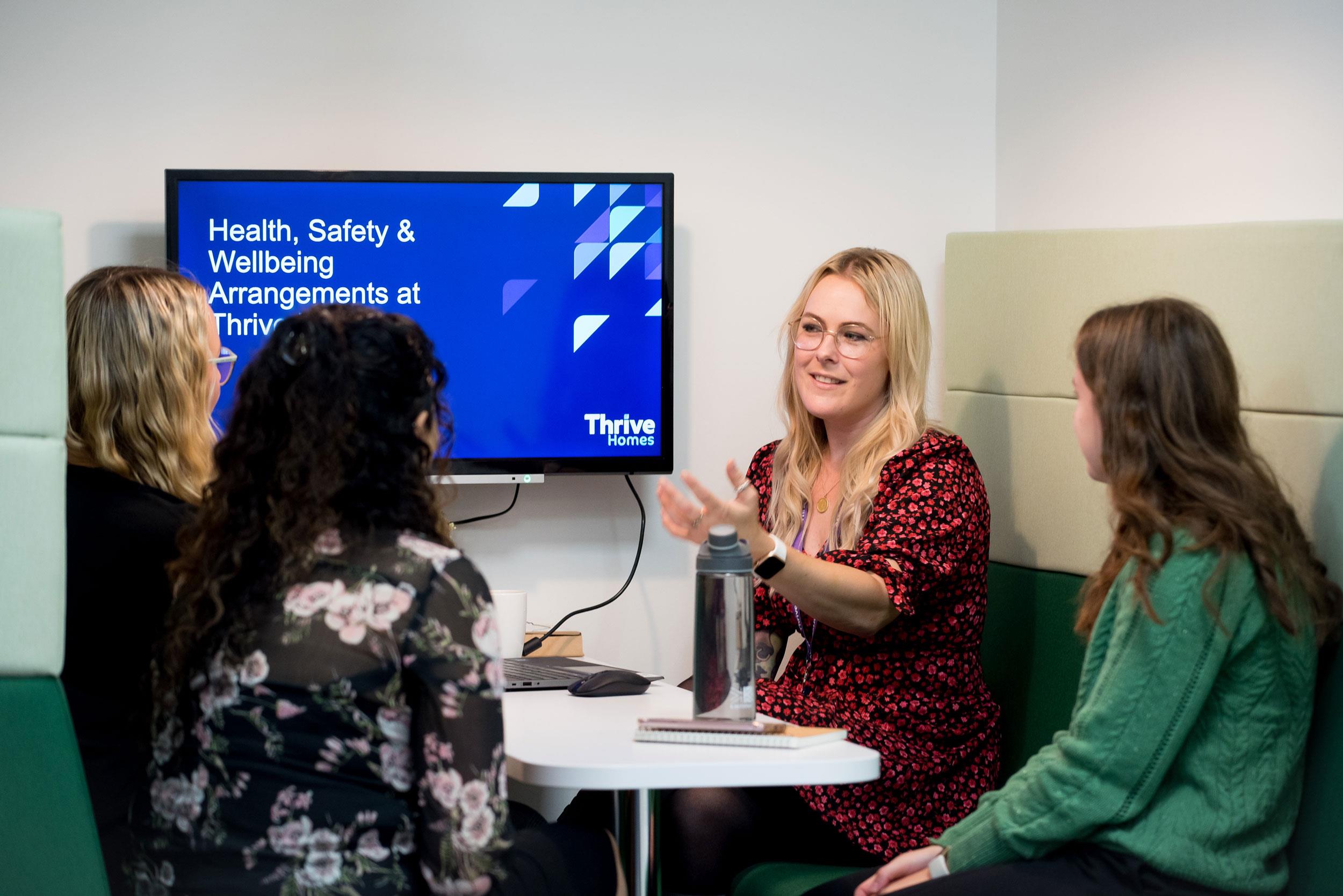 Blond female colleague presenting health & wellbeing induction Blond female colleague presenting health & wellbeing induction