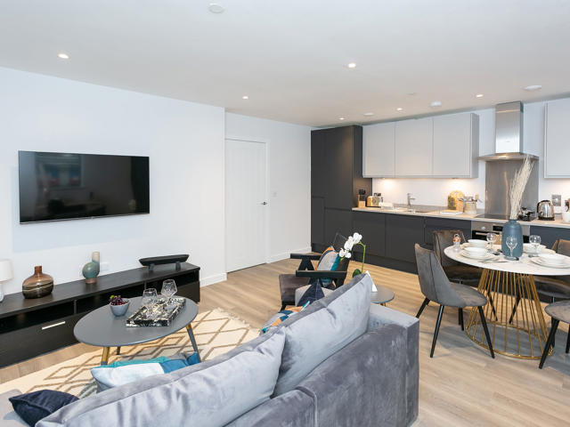 Open plan living room, kitchen & dining room with wall mounted tv. 