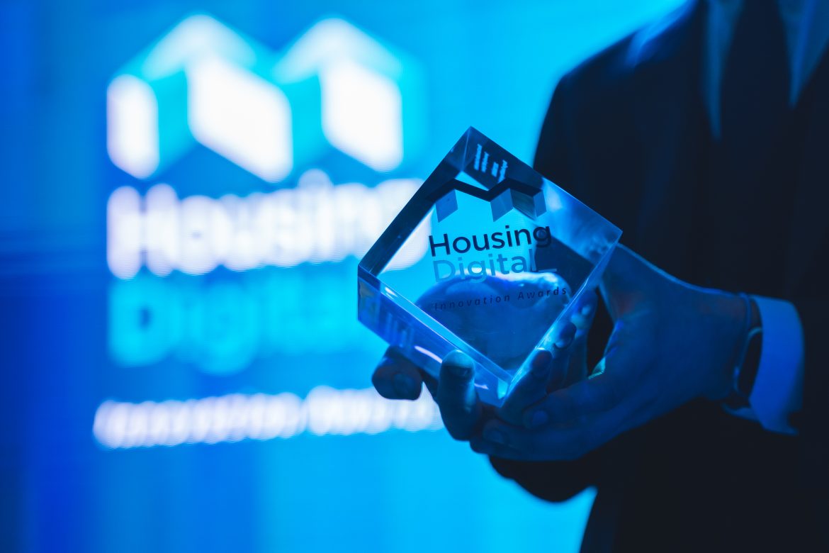 housing digital innovation award trophy in front of projection screen