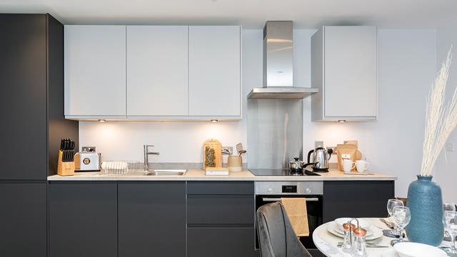 Modern fitted kitchen with dark grey & white cupboards